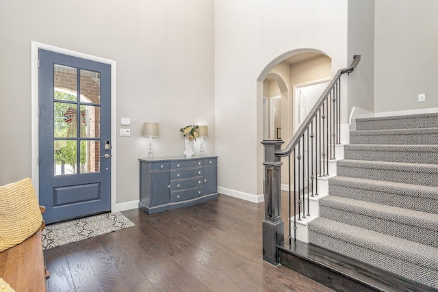 1607 Lilac Ln, Celina, TX 75009 - foyer entrance with dark wood finished floors, arched walkways, baseboards, a high ceiling, and stairway