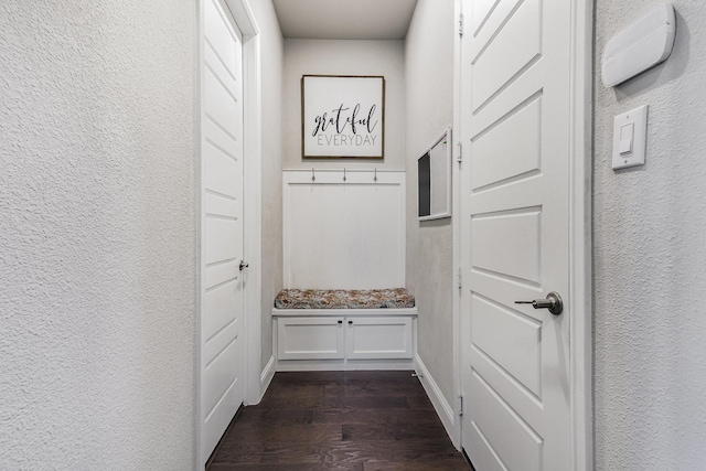 1607 Lilac Ln, Celina, TX 75009 - mudroom with dark wood finished floors, a textured wall, and baseboards