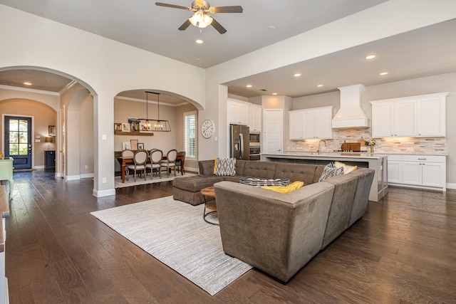 1607 Lilac Ln, Celina, TX 75009 - living room featuring arched walkways, a ceiling fan, dark wood finished floors, baseboards, and recessed lighting