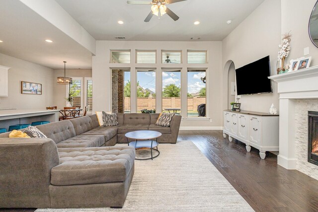 1607 Lilac Ln, Celina, TX 75009 - living area featuring recessed lighting, dark wood-style flooring, ceiling fan, a glass covered fireplace, and baseboards