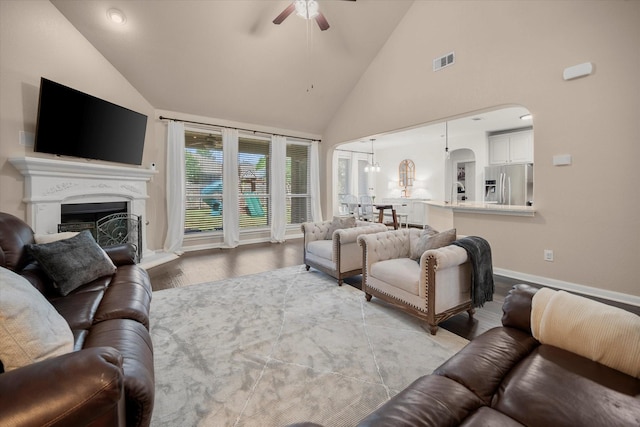 7608 White Fawn Rd, Arlington, TX 76002 - living area featuring a ceiling fan, wood finished floors, baseboards, high vaulted ceiling, and a fireplace with raised hearth
