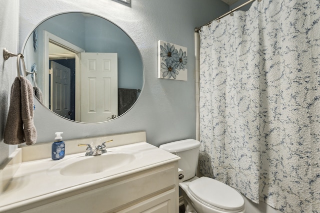 full bathroom featuring toilet, vanity, and a shower with shower curtain