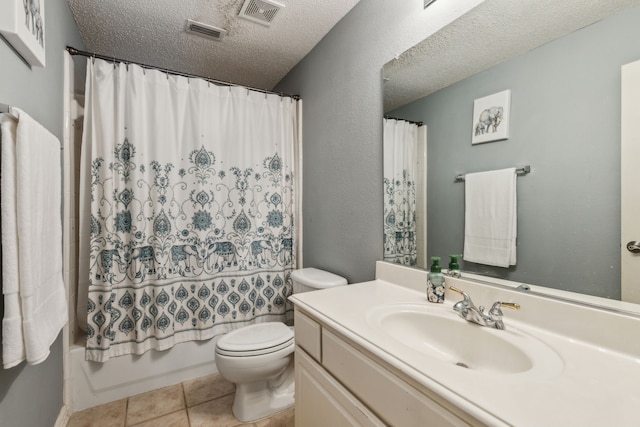 bathroom featuring toilet, a textured ceiling, vanity, shower / bath combo with shower curtain, and tile patterned floors
