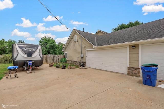 561 Linton Rd, Benton, LA 71006 - view of property exterior featuring driveway, a shingled roof, a garage, and stone siding