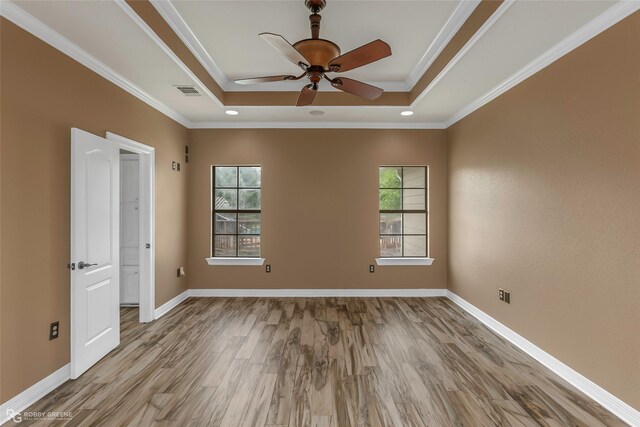 561 Linton Rd, Benton, LA 71006 - unfurnished room with a tray ceiling, wood finished floors, ceiling fan, ornamental molding, and baseboards