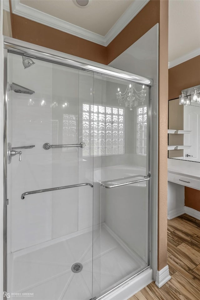 561 Linton Rd, Benton, LA 71006 - full bath featuring ornamental molding, a chandelier, a stall shower, wood finished floors, and baseboards