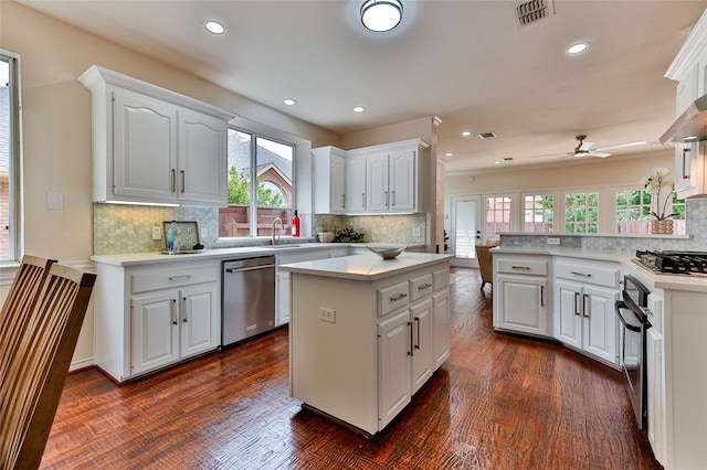 7627 Sweetgum Dr, Irving, TX 75063 - kitchen with stainless steel appliances, decorative backsplash, ceiling fan, white cabinets, and light countertops