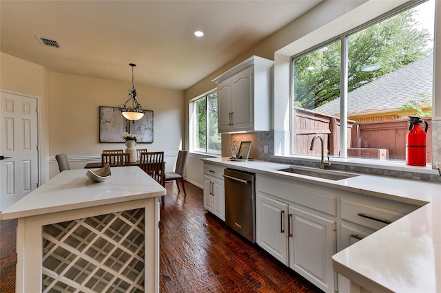 7627 Sweetgum Dr, Irving, TX 75063 - kitchen with dishwasher, a sink, white cabinetry, recessed lighting, and decorative light fixtures