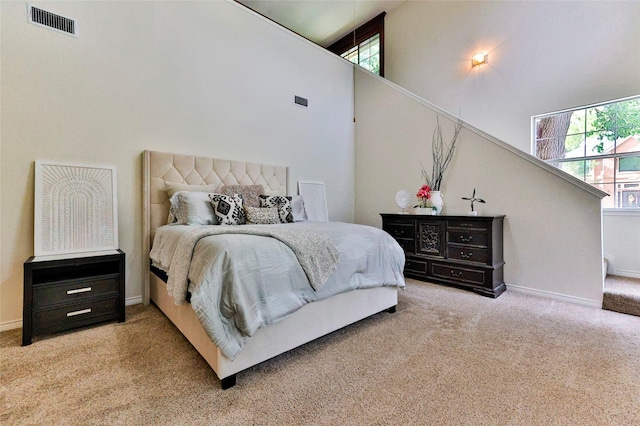 7627 Sweetgum Dr, Irving, TX 75063 - carpeted bedroom featuring a towering ceiling, multiple windows, and baseboards
