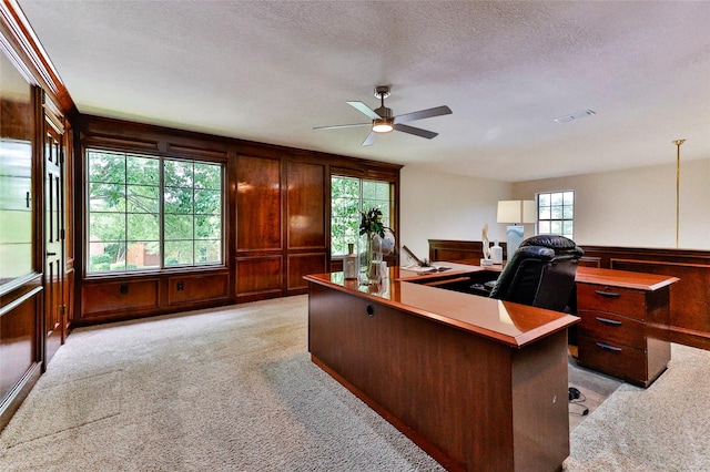 7627 Sweetgum Dr, Irving, TX 75063 - office featuring a ceiling fan, light colored carpet, a textured ceiling, wood walls, and a decorative wall