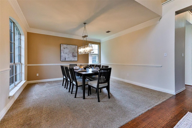 7627 Sweetgum Dr, Irving, TX 75063 - dining space featuring crown molding, a chandelier, baseboards, carpet flooring, and wood finished floors