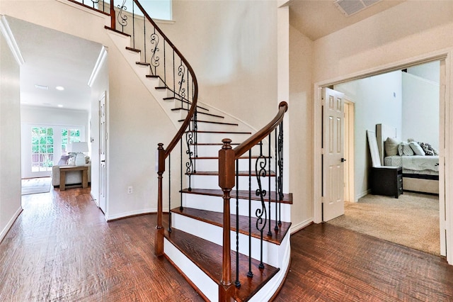 7627 Sweetgum Dr, Irving, TX 75063 - stairway featuring wood finished floors, a high ceiling, and baseboards