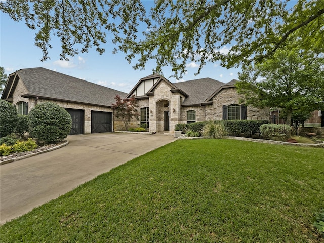 5143 Pond Bluff Way, Fairview, TX 75069 - view of front facade featuring a shingled roof, an attached garage, stone siding, and a front lawn