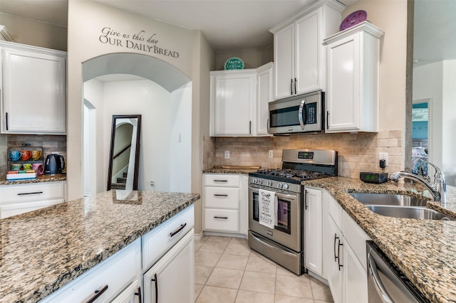 820 Lake Sierra Way, Little Elm, TX 75068 - kitchen with appliances with stainless steel finishes, a sink, light stone countertops, and white cabinetry