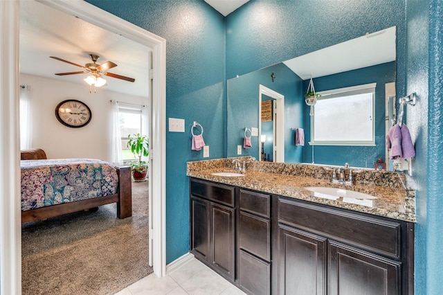 820 Lake Sierra Way, Little Elm, TX 75068 - full bath featuring ensuite bath, tile patterned floors, a ceiling fan, double vanity, and a textured wall