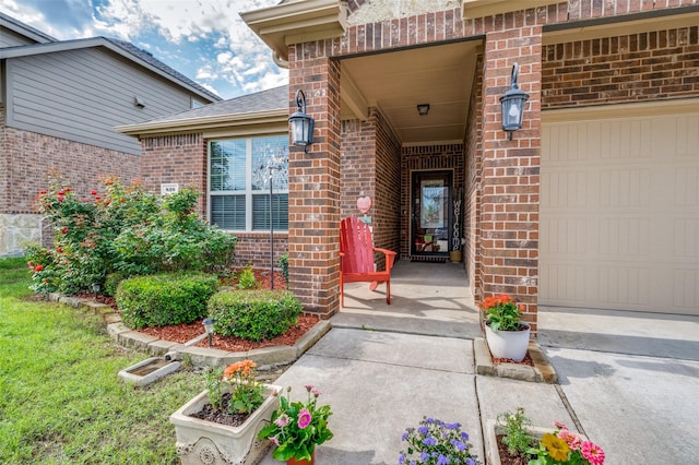 820 Lake Sierra Way, Little Elm, TX 75068 - view of exterior entry featuring brick siding and a garage