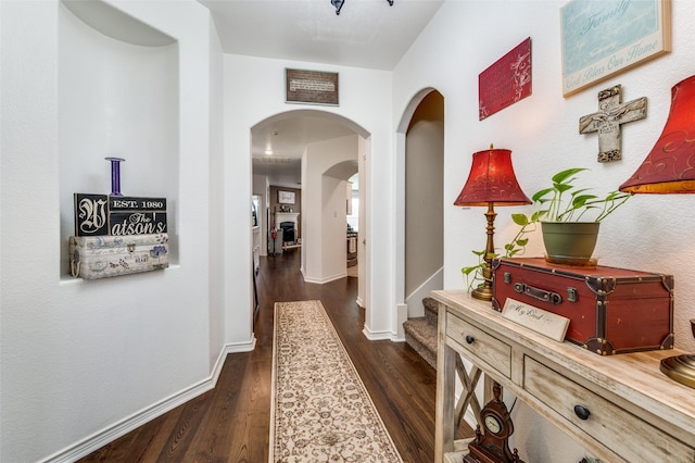 820 Lake Sierra Way, Little Elm, TX 75068 - corridor featuring arched walkways, dark wood finished floors, and baseboards