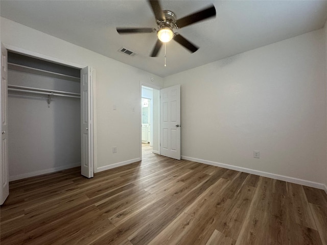 140 Shirley Dr, Lacy Lakeview, TX 76705 - unfurnished bedroom featuring wood finished floors, baseboards, a closet, and ceiling fan