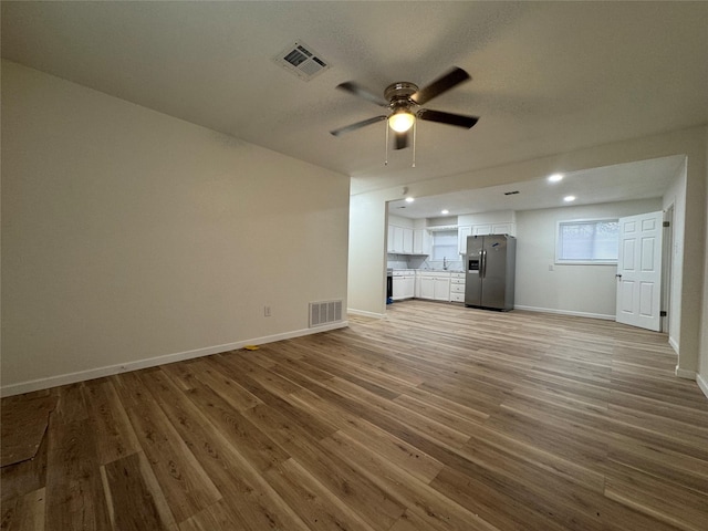 140 Shirley Dr, Lacy Lakeview, TX 76705 - unfurnished living room featuring a ceiling fan, light wood-style flooring, baseboards, and recessed lighting