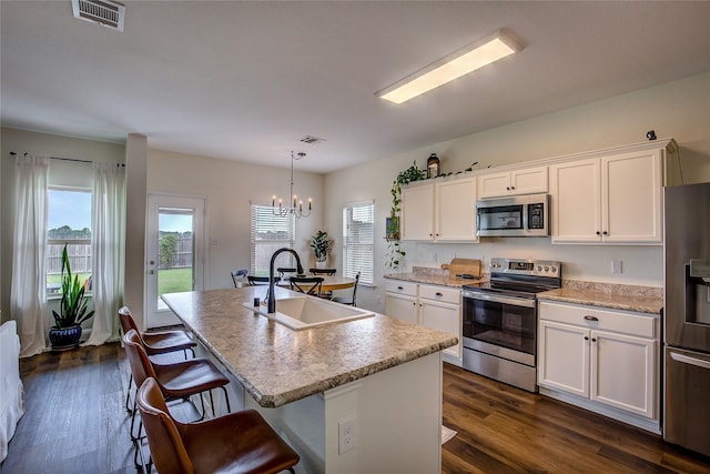 708 Savanna Dr, Josephine, TX 75173 - kitchen with stainless steel appliances, a sink, a chandelier, an island with sink, and white cabinets