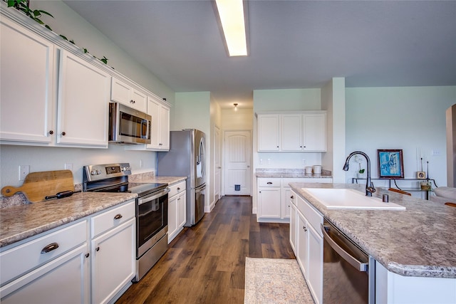 708 Savanna Dr, Josephine, TX 75173 - kitchen with appliances with stainless steel finishes, a sink, white cabinets, a center island with sink, and dark wood finished floors