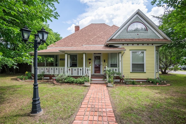 306 College St, Red Oak, TX 75154 - view of front of home with a porch, a chimney, a front lawn, and roof with shingles