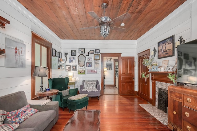 306 College St, Red Oak, TX 75154 - living area with wood ceiling, crown molding, dark wood finished floors, a ceiling fan, and wooden walls