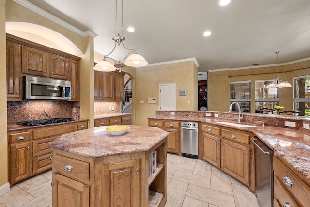 1405 Micah Way, Keller, TX 76248 - kitchen featuring appliances with stainless steel finishes, a sink, ornamental molding, light stone counters, and tasteful backsplash