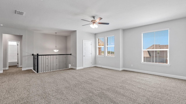 8721 Leafy Ln, Justin, TX 76247 - carpeted empty room with ceiling fan, a textured ceiling, and baseboards