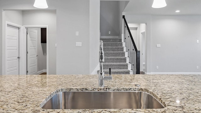 8721 Leafy Ln, Justin, TX 76247 - kitchen with a sink, light stone countertops, recessed lighting, and baseboards