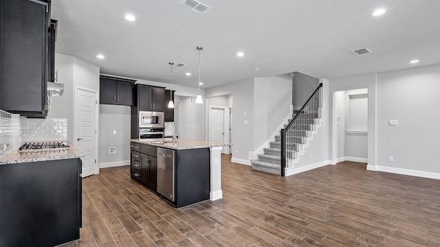 8721 Leafy Ln, Justin, TX 76247 - kitchen featuring appliances with stainless steel finishes, baseboards, decorative backsplash, light stone countertops, and recessed lighting