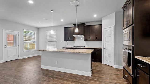 8721 Leafy Ln, Justin, TX 76247 - kitchen featuring appliances with stainless steel finishes, a sink, dark wood-type flooring, tasteful backsplash, and recessed lighting