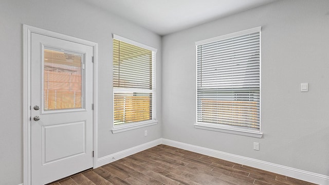 8721 Leafy Ln, Justin, TX 76247 - doorway to outside with dark wood-type flooring, baseboards, and healthy amount of natural light