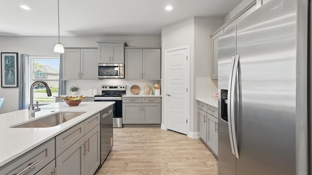 1303 Finley Dr, Mansfield, TX 76063 - kitchen with stainless steel appliances, gray cabinetry, a sink, recessed lighting, and light countertops