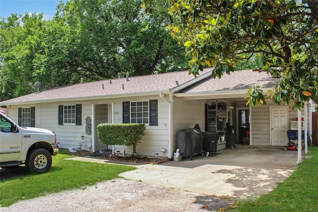 515 Lois St, Aubrey, TX 76227 - single story home with concrete driveway, a carport, roof with shingles, and a front lawn