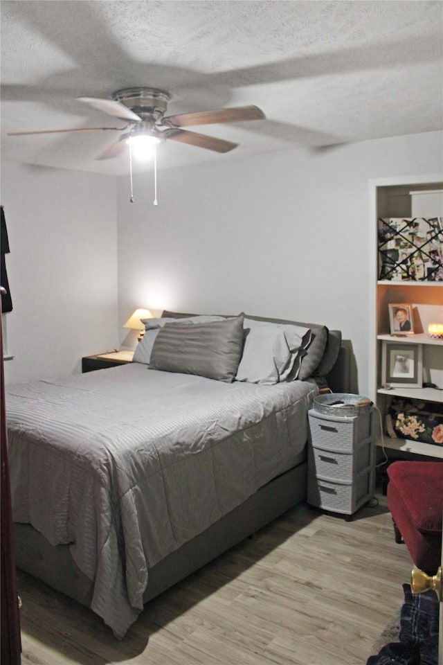 515 Lois St, Aubrey, TX 76227 - bedroom with a textured ceiling, light wood-type flooring, and a ceiling fan