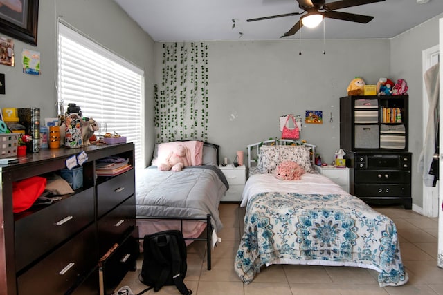 bedroom featuring tile patterned floors and a ceiling fan