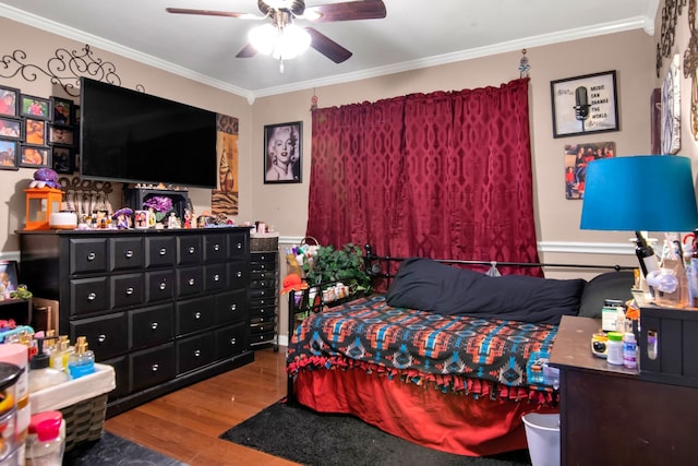 bedroom featuring crown molding, wood finished floors, and ceiling fan