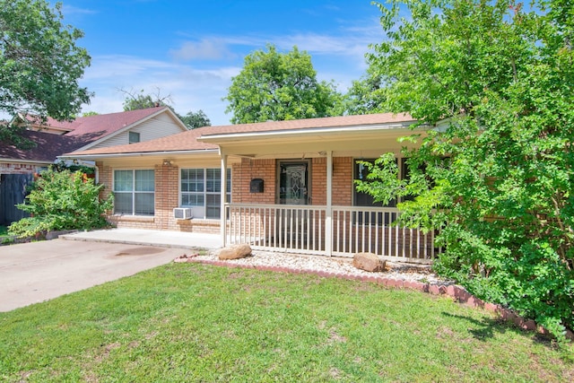 ranch-style house featuring covered porch, a front yard, and brick siding