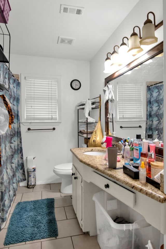 full bath featuring tile patterned flooring, toilet, vanity, and curtained shower