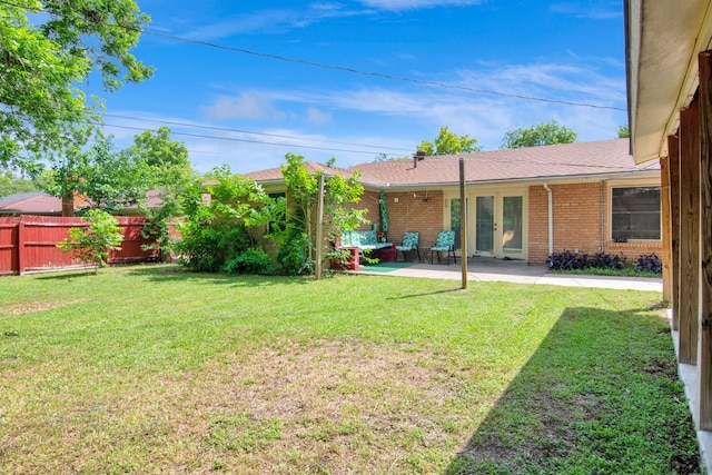 view of yard featuring french doors and a patio