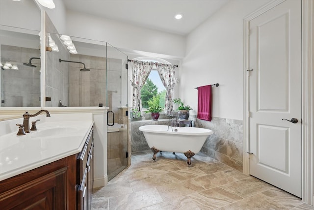 2801 Spring Oaks Dr, Highland Village, TX 75077 - bathroom featuring a stall shower, vanity, tile walls, a freestanding bath, and wainscoting