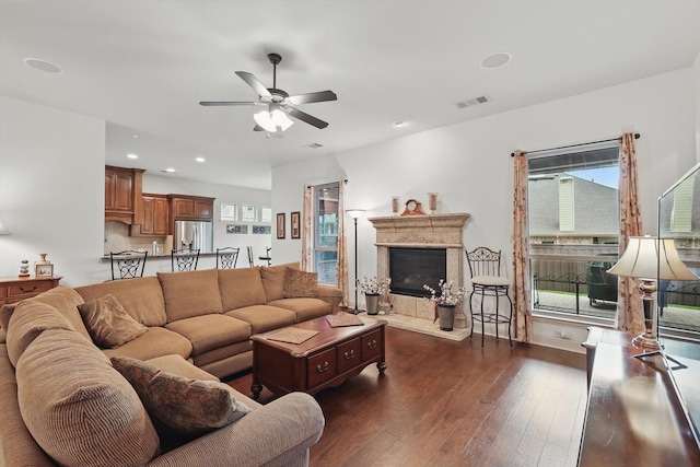 2801 Spring Oaks Dr, Highland Village, TX 75077 - living area featuring a ceiling fan, dark wood finished floors, a fireplace with raised hearth, recessed lighting, and baseboards