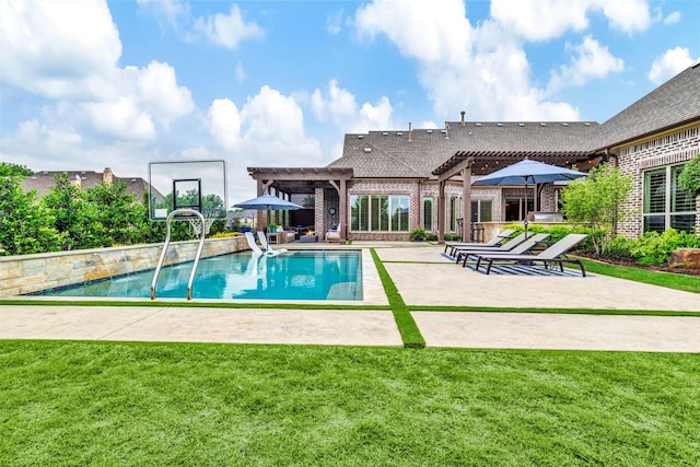 outdoor pool with a pergola, a yard, and a patio