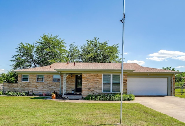 6115 Overlake Dr, Fort Worth, TX 76135 - ranch-style house with a front yard, concrete driveway, an attached garage, and stone siding