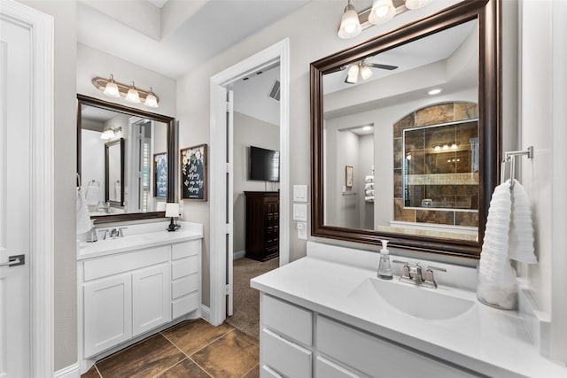 12092 Burnt Prairie Ln, Frisco, TX 75035 - full bathroom featuring ceiling fan, two vanities, a tile shower, tile patterned floors, and baseboards