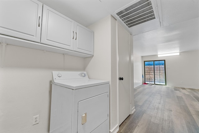 1811 E Grauwyler Rd Unit 138, Irving, TX 75061 - laundry area featuring washer / dryer, light wood-style floors, baseboards, and cabinet space