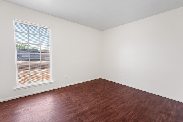 1811 E Grauwyler Rd Unit 138, Irving, TX 75061 - empty room featuring dark wood-type flooring and baseboards