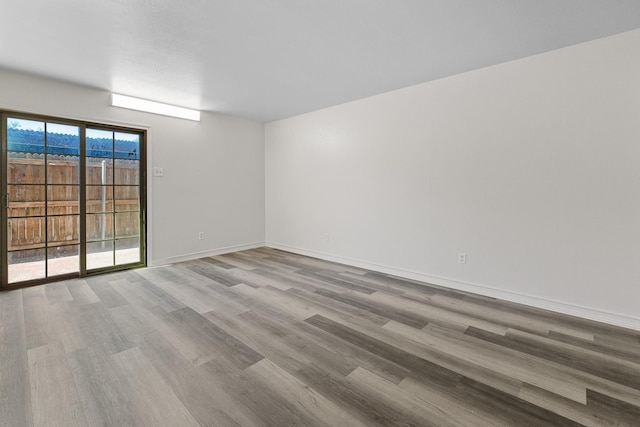 1811 E Grauwyler Rd Unit 138, Irving, TX 75061 - unfurnished room featuring wood finished floors and baseboards