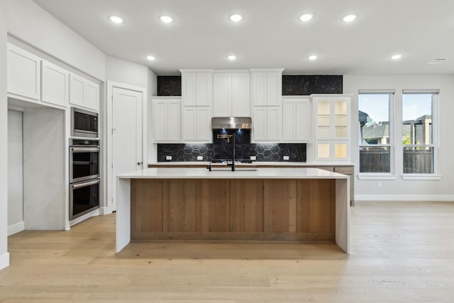 2921 Citation Rd, Celina, TX 75009 - kitchen featuring under cabinet range hood, appliances with stainless steel finishes, baseboards, decorative backsplash, and white cabinetry
